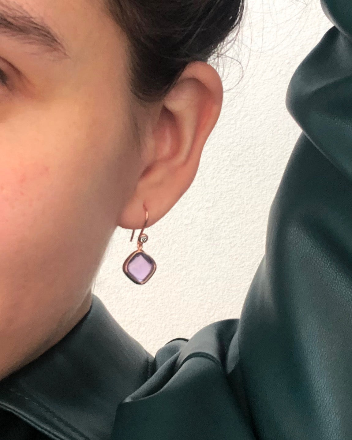 A pair of square amethyst gold earrings in rose gold with diamond accents, hanging from ear hooks.