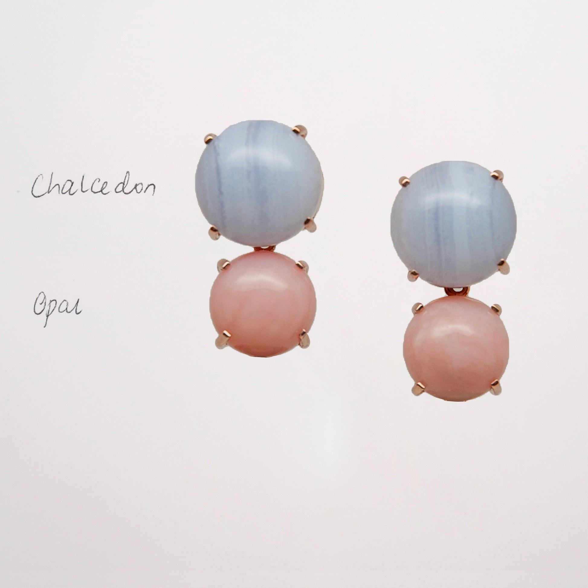 Chalcedony and Pink Opal as a pair of pink and blue gemstone earrings on white background set in rose gold