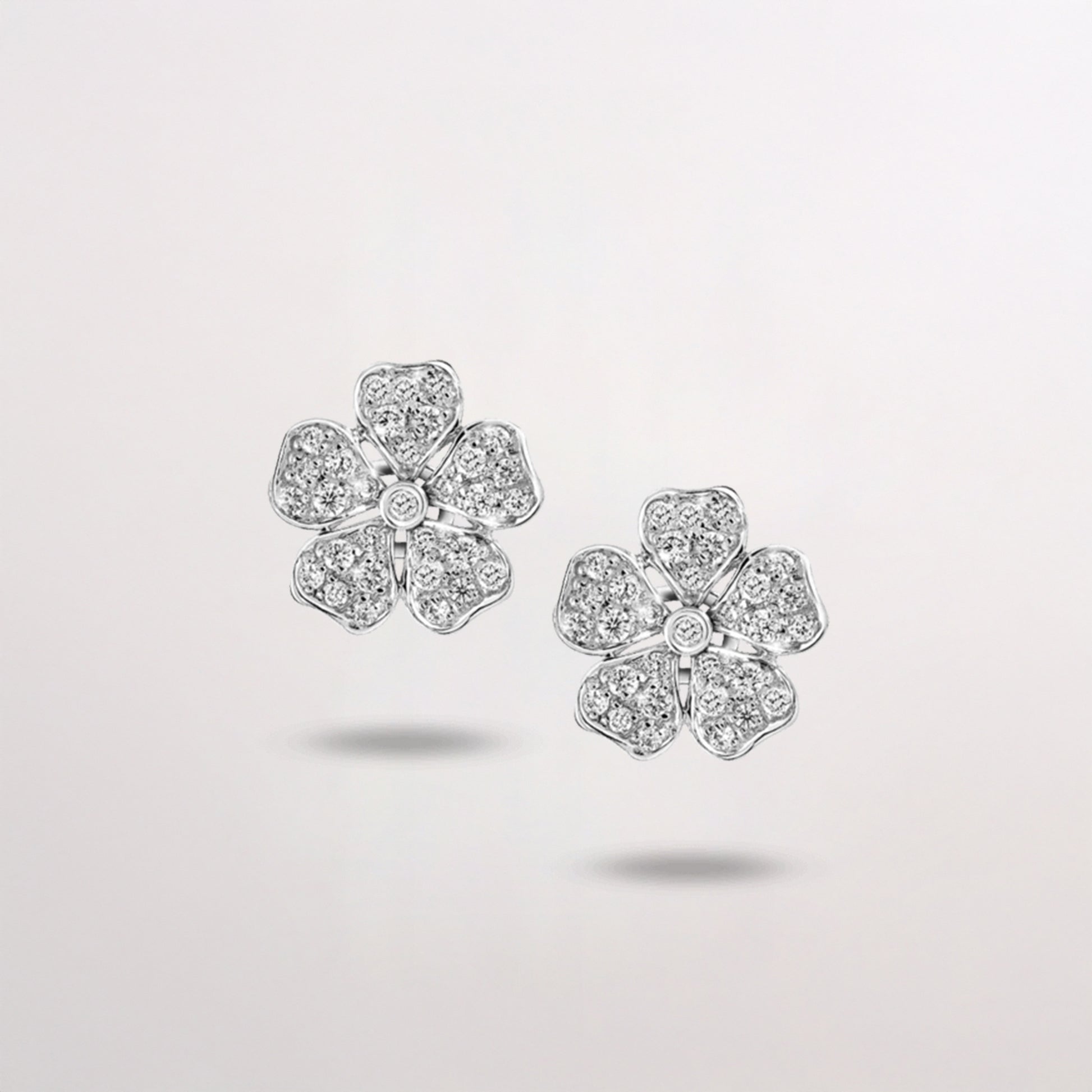 Flower-shaped diamond earrings on white background