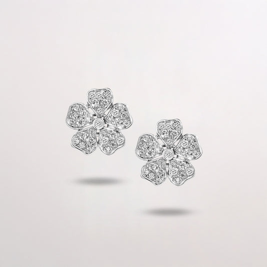 Flower-shaped diamond earrings on white background