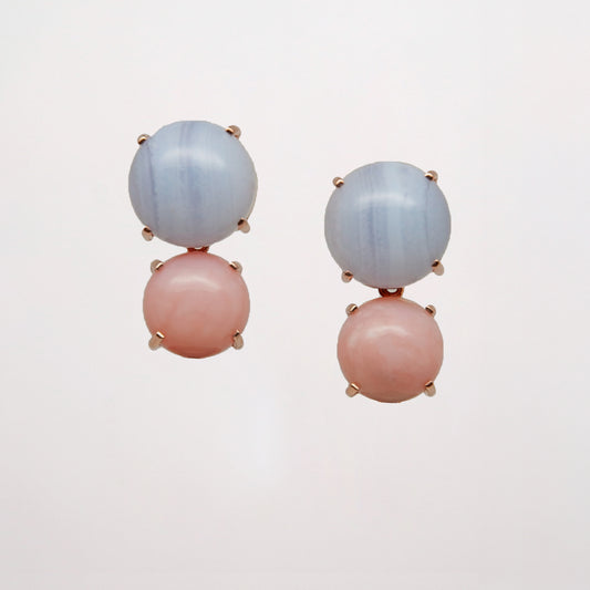 Pair of earrings with pink and blue gemstone on a light gray background