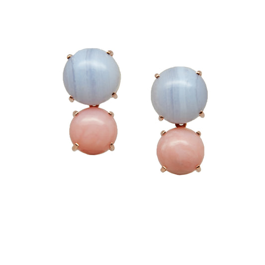 Pair of earrings with pink and blue gemstone on white background